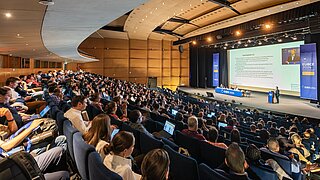 Picture shows participants of the EUBCE 2024 sitting in an auditorium and listening to a lecture.