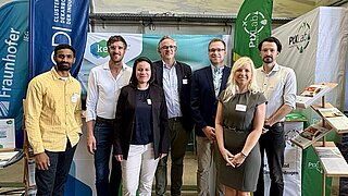 Teamfoto der Mitarbeitenden aus dem KEI und PtX Lab Lausitz vor dem gemeinsamen Messestand