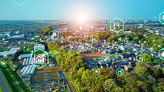 Aerial photograph of a city from above with symbols for recycling and green technology.