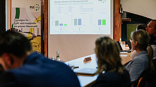 Participants at the Maritime Round Table are looking at a infographic